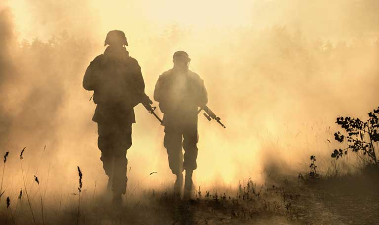 Two soldiers walking in a haze