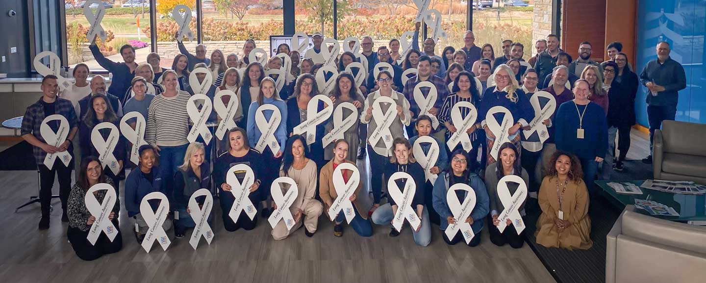 CHEST staff pose with the organization’s white ribbons in November 2024.