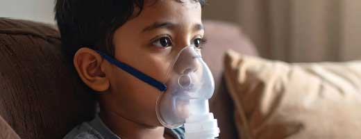 Young boy uses nebulizer