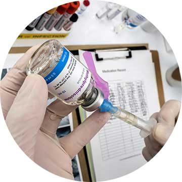 Someone with gloves extracting methylprednisolone from a jar with a syringe