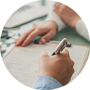 A person holding a pen over a clipboard
